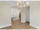 Open-concept design with hardwood floors and views into the kitchen and staircase at 1413 Kenilworth Ave, Charlotte, NC 28203