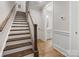 Elegant staircase with wooden steps and a white banister, seamlessly connecting different levels of the home at 1413 Kenilworth Ave, Charlotte, NC 28203