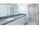Bright bathroom featuring double sink vanity with granite countertop and white cabinets at 134 Asmodean Ln, Troutman, NC 28166