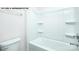 Bright bathroom featuring a pristine white bathtub with shower and safety bars at 134 Asmodean Ln, Troutman, NC 28166