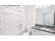 Bright bathroom featuring a shower-tub combo, granite countertop vanity, and neutral decor at 134 Asmodean Ln, Troutman, NC 28166