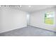 Bedroom with neutral carpet, white walls, and a window overlooking the lawn at 134 Asmodean Ln, Troutman, NC 28166