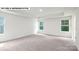 Bright bedroom featuring neutral carpet, tray ceilings and two windows for natural light at 134 Asmodean Ln, Troutman, NC 28166
