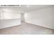 Open concept bonus room with neutral carpet, bright walls and a door to another room at 134 Asmodean Ln, Troutman, NC 28166
