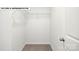 Walk-in closet with carpeted floors, wire shelving, and a white door at 134 Asmodean Ln, Troutman, NC 28166
