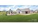 Community center, playground, and swimming pool set amongst single Gathering homes at 134 Asmodean Ln, Troutman, NC 28166
