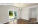 Bright dining room featuring hardwood floors, modern lighting fixture, and a sliding glass door at 134 Asmodean Ln, Troutman, NC 28166