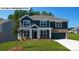 Inviting two-story home with a combination of siding and brick accents, enhanced by a well-manicured front lawn at 134 Asmodean Ln, Troutman, NC 28166