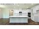 Modern kitchen featuring white cabinets, a large island with seating, and sleek pendant lighting at 134 Asmodean Ln, Troutman, NC 28166