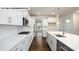Modern kitchen with white cabinets, stainless steel appliances, quartz countertops, and hardwood floors at 134 Asmodean Ln, Troutman, NC 28166