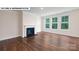 Bright living room featuring a fireplace, large windows, and hardwood floors at 134 Asmodean Ln, Troutman, NC 28166