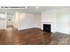 Living room featuring a fireplace, hardwood floors, a staircase, and neutral paint at 134 Asmodean Ln, Troutman, NC 28166