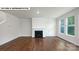 Living room featuring a fireplace, large windows, and hardwood floors at 134 Asmodean Ln, Troutman, NC 28166