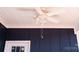 White ceiling fan with caged light fixture against blue paneled wall at 1432 Blackbird Dr, Clover, SC 29710