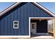 Side view of a house with blue siding, white trim and covered porch at 1432 Blackbird Dr, Clover, SC 29710