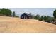 A modern, blue home with covered porch is the focal point, surrounded by a large, grassy lot at 1432 Blackbird Dr, Clover, SC 29710
