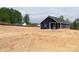 Modern blue home with a covered porch on a spacious lot, featuring a clean and simple design at 1432 Blackbird Dr, Clover, SC 29710