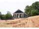 Charming blue house with white trim, featuring a covered porch and lovely outdoor space at 1432 Blackbird Dr, Clover, SC 29710