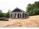 Lovely blue home with white trim, a covered porch, and a welcoming design in a picturesque setting at 1432 Blackbird Dr, Clover, SC 29710