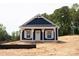 Charming blue home with white trim, a covered porch, and classic design elements at 1432 Blackbird Dr, Clover, SC 29710