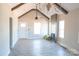 Bright, open living area with vaulted ceilings, modern lighting, and seamless flow to the kitchen at 1432 Blackbird Dr, Clover, SC 29710