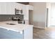 Modern kitchen with white cabinets, stainless steel appliances, and a breakfast bar with elegant countertops at 1432 Blackbird Dr, Clover, SC 29710