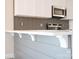 Close-up of a kitchen island with a sink, elegant countertops, and classic support brackets at 1432 Blackbird Dr, Clover, SC 29710