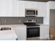 Modern kitchen showcasing stainless steel appliances, including oven and stovetop, with light countertops at 1432 Blackbird Dr, Clover, SC 29710