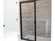 Modern bathroom shower featuring sleek black frame and decorative tile with convenient corner shelves at 1432 Blackbird Dr, Clover, SC 29710