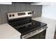 Close-up of a modern stainless steel stovetop with sleek controls and light countertops at 1432 Blackbird Dr, Clover, SC 29710