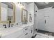 Beautiful bathroom with double sinks, marble countertops, and a glass-enclosed shower at 18009 Kings Point Dr # C, Cornelius, NC 28031