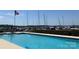 Relaxing community pool overlooking the marina and docked boats, showcasing waterfront living at 18009 Kings Point Dr # C, Cornelius, NC 28031