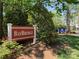 Baybridge community sign surrounded by lush landscaping and trees on a sunny day at 18009 Kings Point Dr # C, Cornelius, NC 28031