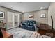 Cozy living room featuring comfortable blue seating, natural light, and a functional workspace at 18009 Kings Point Dr # C, Cornelius, NC 28031