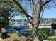 Outdoor picnic area under trees by the lake featuring blue tables and grill at 18009 Kings Point Dr # C, Cornelius, NC 28031