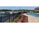 Community pool and harbor showcasing flowers and a black iron fence at 18009 Kings Point Dr # C, Cornelius, NC 28031
