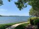 Expansive water view with a well-maintained grassy area and walkway; beautiful lake scenery at 18009 Kings Point Dr # C, Cornelius, NC 28031