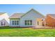 Well-maintained backyard featuring a patio, lush grass, and mature trees at 229 River Birch Dr, Salisbury, NC 28146