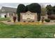 Stone community sign surrounded by lush landscaping and colorful flower beds at 229 River Birch Dr, Salisbury, NC 28146