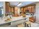 Well-lit kitchen features wood cabinetry, light countertops, with a breakfast bar and stainless appliances at 229 River Birch Dr, Salisbury, NC 28146
