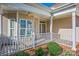 Charming covered front porch with a ceiling fan and garden views at 229 River Birch Dr, Salisbury, NC 28146