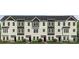 Three-story townhouse exterior with white and dark gray siding, complemented by black window frames and well-maintained landscaping at 234 E Morehouse Ave # Twnh E, Mooresville, NC 28117