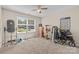 Versatile bedroom filled with exercise equipment and natural light from a large window at 2341 Shannon Dr, Belmont, NC 28012