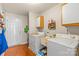 Functional laundry room with washer, dryer, utility sink, and storage at 2341 Shannon Dr, Belmont, NC 28012