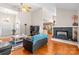 Bright living room with hardwood floors, ceiling fan, and a cozy fireplace at 2341 Shannon Dr, Belmont, NC 28012