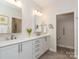 Bathroom featuring double sinks, elegant fixtures, and a separate toilet area at 2342 Wesley Landing Rd, Waxhaw, NC 28173