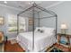 Airy bedroom showcasing a canopy bed, shuttered window, and classic decor at 2342 Wesley Landing Rd, Waxhaw, NC 28173
