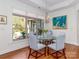 Elegant dining area featuring a glass-top table, chandelier, and a view of the outdoor patio at 2342 Wesley Landing Rd, Waxhaw, NC 28173