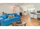 Comfortable living room featuring a bright blue couch and wood floors, adjacent to a dedicated office space at 2342 Wesley Landing Rd, Waxhaw, NC 28173