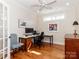 Well-lit home office with hardwood floors, a built-in desk, and a chair at 2342 Wesley Landing Rd, Waxhaw, NC 28173